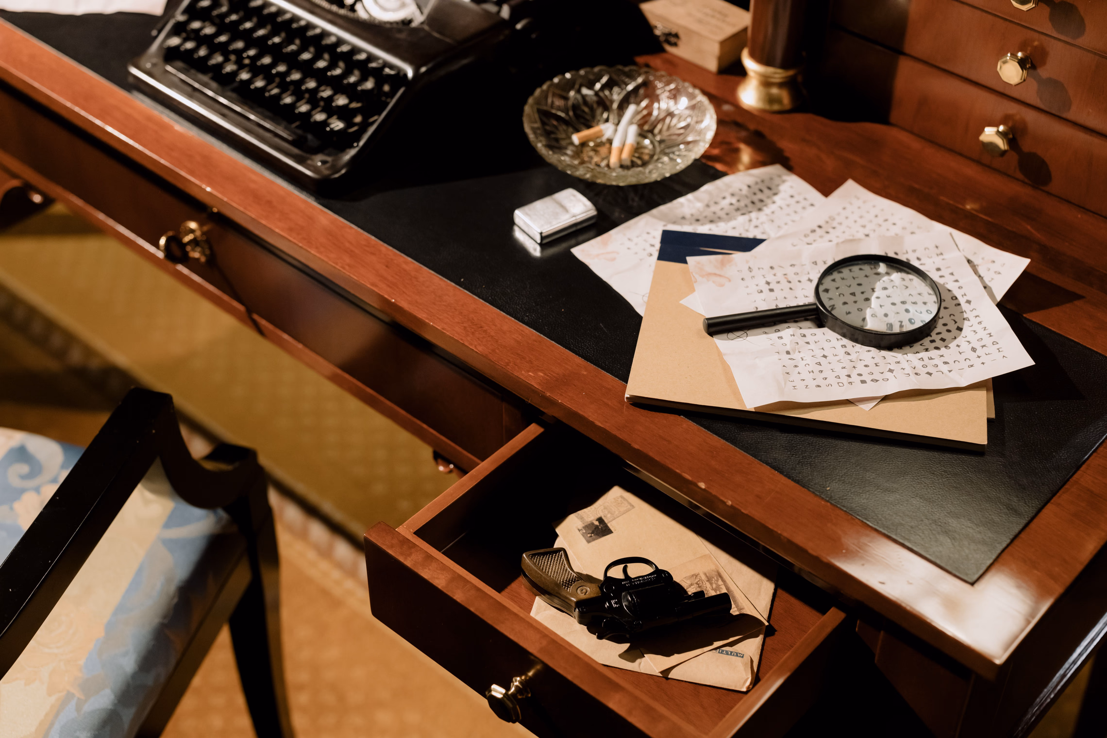 A moody vintage desk with a magnifying glass and scattered documents in low light