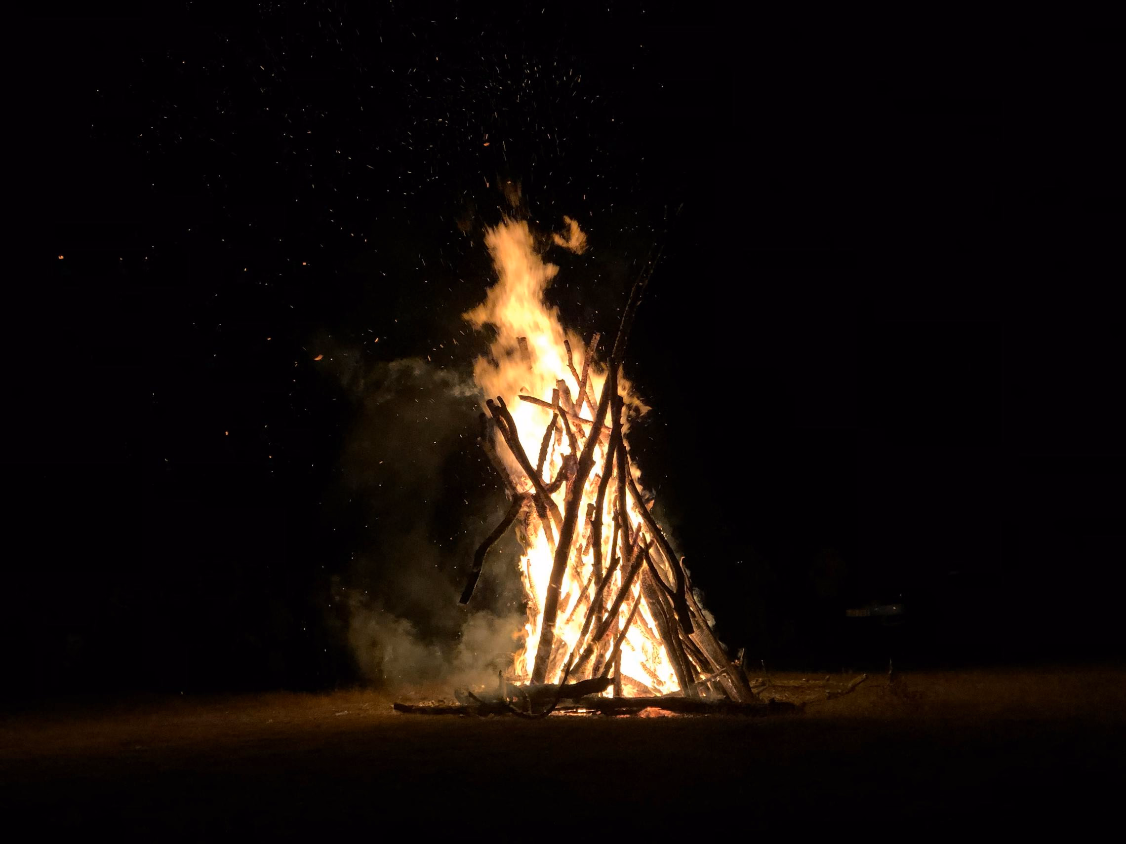 Bonfire on a hilltop at sunset evoking ancient Celtic fire festivals