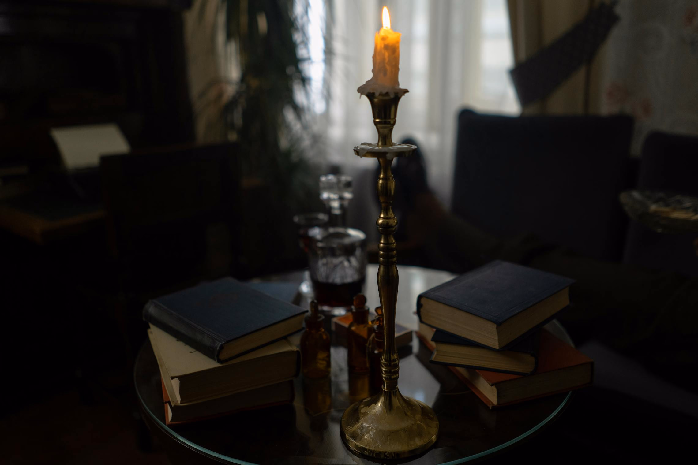 A dark hallway with red uplighting along the baseboards and a silhouetted figure at the far end
