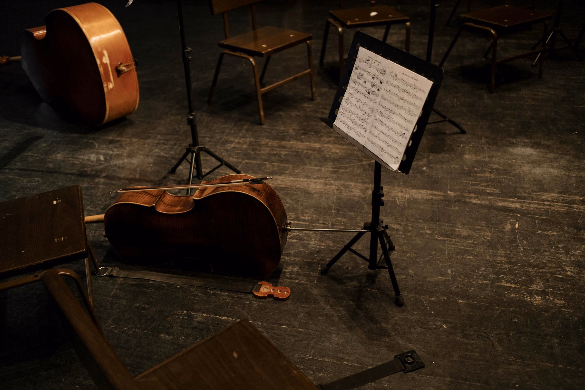 Orchestra pit with dramatic red and amber lighting and wisps of fog